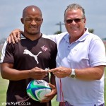 Cheeky Watson hands Tiger Mangweni his coaches whistle.Cheeky Watson hands Tiger Mangweni his coaches whistle.